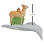 Glass deer ornament on a hand with measurement label