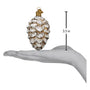 Decorative vintage glass ornament shaped like a pine cone held in a hand with a measurement label indicating its size.