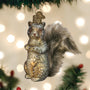 Vintage Glass squirrel ornament on a Christmas tree with lights in the background