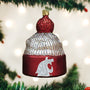 Decorative ornament shaped like a beanie with a logo, hanging on a Christmas tree.