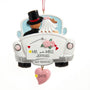 Personalized wedding car ornament featuring a bride and groom in a white getaway car, shown with Mr. and Mrs. last name personalization and a wedding date on the dangling pink heart.