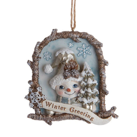 Snowman ornament in a rustic twig-style frame with a snowy tree, blue background, snowflake accents, and a Winter Greeting banner across the bottom.