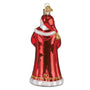 Glass ornament of a figure in a red robe with gold accents on a white background