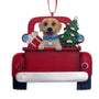 Yellow Lab Dog Christmas ornament in a red truck with a tree and presents on a white background