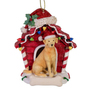 Yellow Labrador Retriever wearing a Santa hat in a red dog house Christmas ornament decorated with colorful lights and holly.