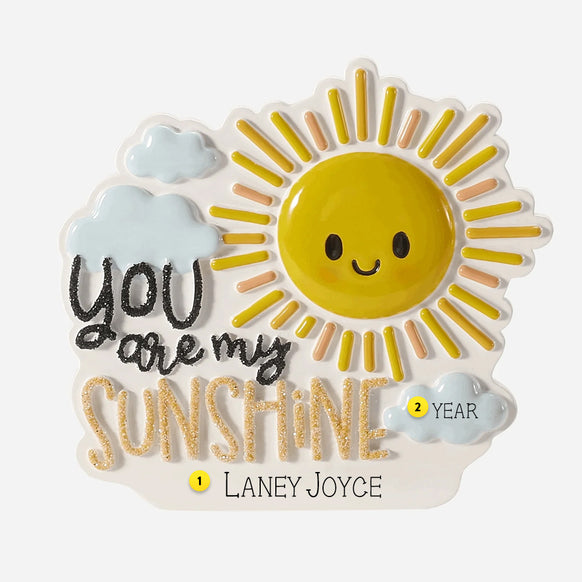 Decorative Ornament with a sun design and 'You are my sunshine' text on a white back round