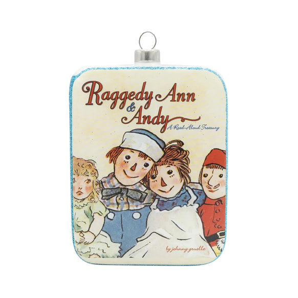 Glass Raggedy Ann & Andy book cover ornament featuring an illustrated vintage-style front with the classic characters and title text.