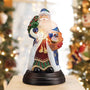 Regal Father Christmas Light glowing in a festive holiday display with Christmas trees in the background