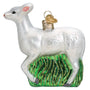 Seneca White Deer Christmas ornament with glitter standing on green tall grass.
