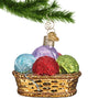 Basket of yarn glass Christmas ornament hanging by a gold swirl hook