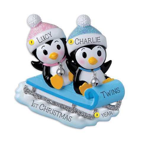 Blue and Pink Twin Penguins Sledding Ornament