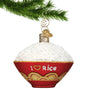 Red Bowl with words I (heart shaped) Rice filled with rice hanging by a gold hook from a Christmas tree branch