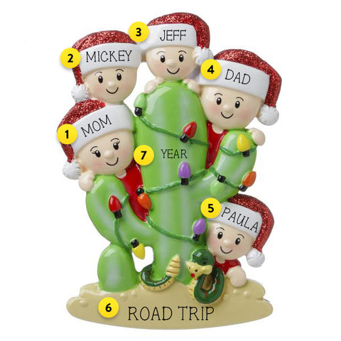 FAMILY OF FIVE HIDING BEHIND A CACTUS ORNAMENT