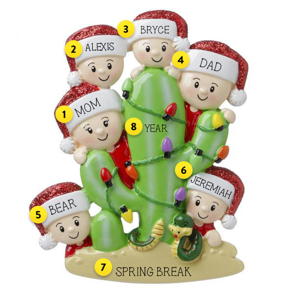 FAMILY OF SIX HIDING BEHIND A CACTUS ORNAMENT