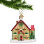 Glass Christmas House hanging from a gold swirl hook on a Christmas tree branch