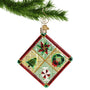 glass quilt Christmas ornament hanging from a gold swirl hook