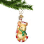 Christmas Mouse swinging on Candy Cane blown glass ornament hanging by a gold swirl hook on a Christmas tree branch
