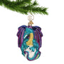 Turquoise and Purple Glass Dragon on orb ornament hanging from a Christmas tree branch from a gold swirl hook