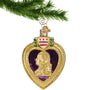 Glass Military Purple Heart Ornament hanging by a gold swirl hook from a Christmas tree branch