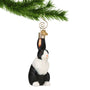 Glass black and white bunny ornament hanging by a gold swirl hook on a Christmas Tree Branch