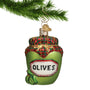 Glass Christmas Ornament that looks like a jar of olives with green and red checkered cover hanging from a gold swirl hanger on a branch