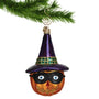 Jack o'lantern carved pumpkin ornament wearing a witch's hat