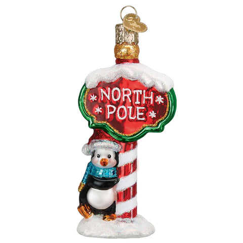 Penguin leaning on North Pole Sign Old World Christmas 
