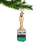 Paint brush ornament hanging by a gold swirl hook
