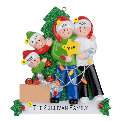 Personalized Family of Four Ornament depicting family decorating the Christmas tree with lights, ornaments, and a star