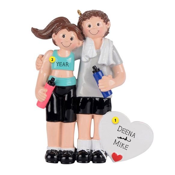 Couple working out holding water bottles with personalized heart ornament 