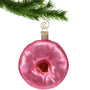 Pink donut ornament hanging by a gold swirl hook