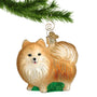 Glass dog ornament Pomeranian hanging by a gold swirl hook