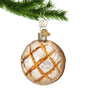 Glass Sourdough Bread Ornament hanging by a gold swirl hook from a Christmas tree branch