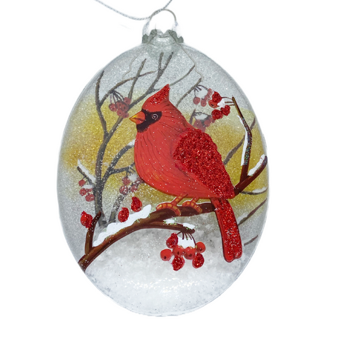 Glass Oval Disc Ornament with Cardinals in a Snowy Scene backdrop