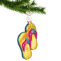 Glass yellow sandals ornament hanging by a gold hook 